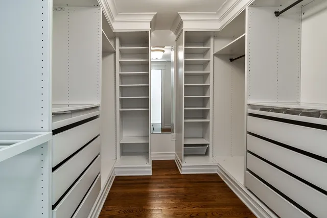 a bathroom with a double vanity sink a mirror and a bathtub