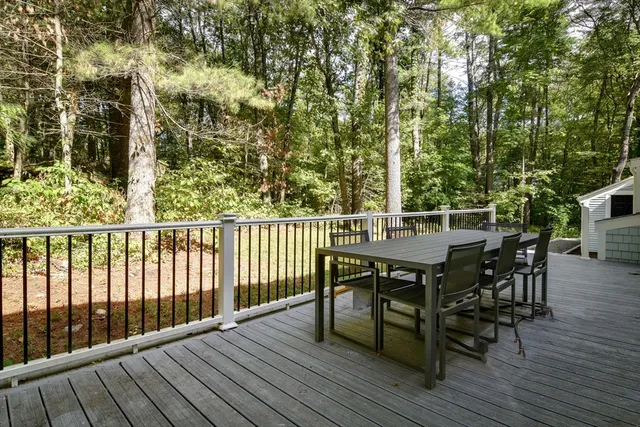 a backyard of a house with yard table and chairs