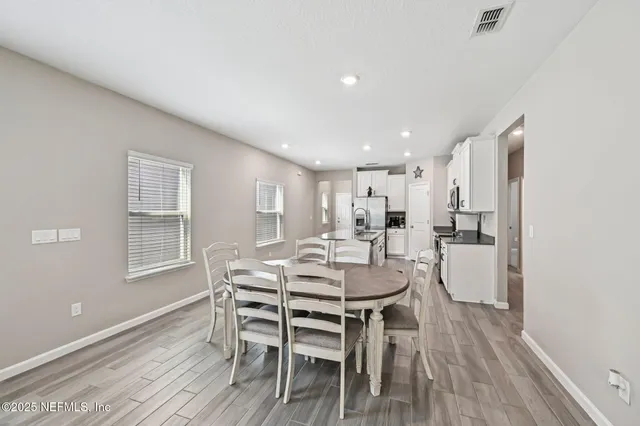 a view of a dining room with furniture and wooden floor