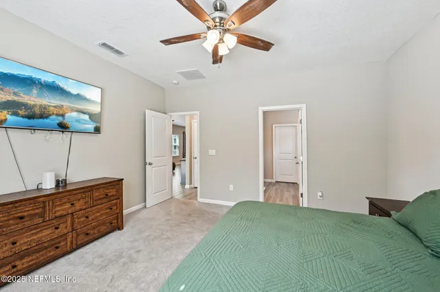 a bedroom with a bed and a dresser