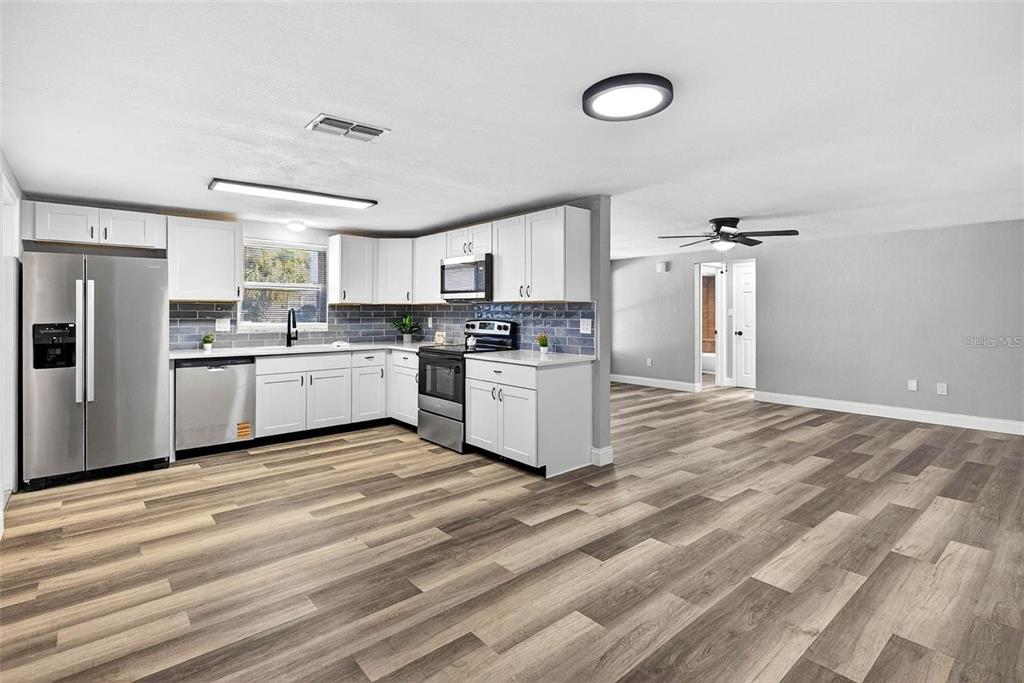 10933 Premier Avenue Port Richey, FL 34668 - Photo 2 of 12 a kitchen with a stove a refrigerator and a sink