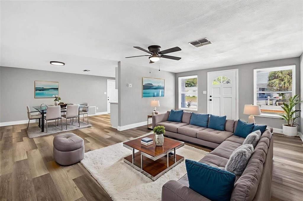 10933 Premier Avenue Port Richey, FL 34668 - Photo 4 of 12 a living room with furniture kitchen view and a window