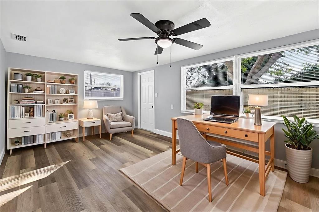 10933 Premier Avenue Port Richey, FL 34668 - Photo 5 of 12 a living room with furniture a flat screen tv and a large window