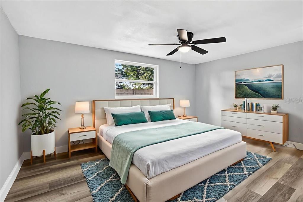 10933 Premier Avenue Port Richey, FL 34668 - Photo 8 of 12 a bedroom with a bed and a flat screen tv