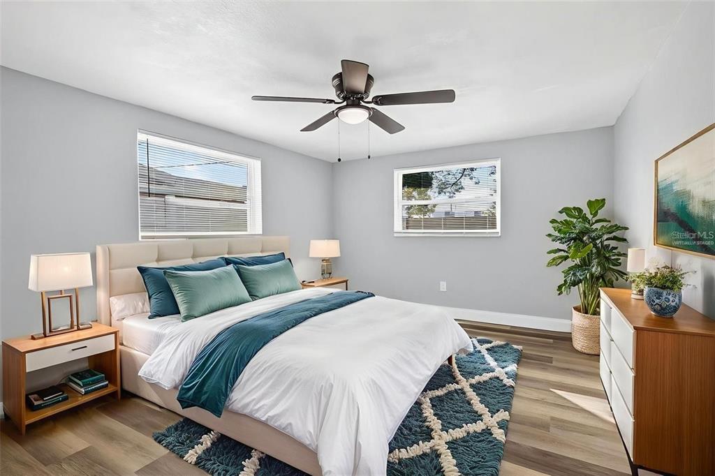 10933 Premier Avenue Port Richey, FL 34668 - Photo 9 of 12 a bedroom with bed and a potted plant