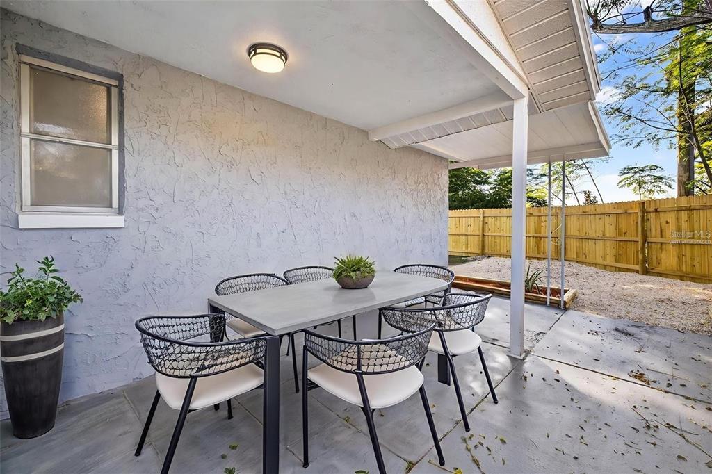 10933 Premier Avenue Port Richey, FL 34668 - Photo 10 of 12 a view of a chairs and table in patio