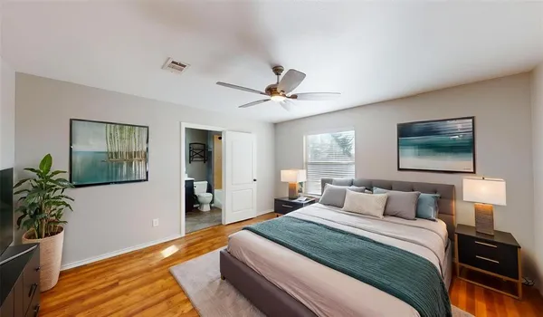 a bedroom with a bed and a potted plant