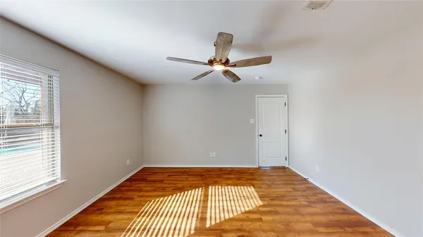 a bedroom with a bed and a chandelier fan