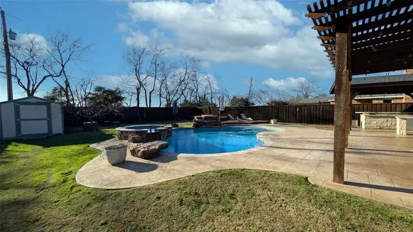 a view of a swimming pool with a yard