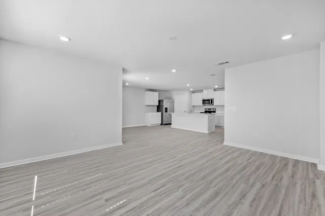 a view of a kitchen with a sink and wooden floor