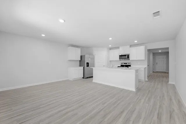 a view of kitchen with wooden floor and window
