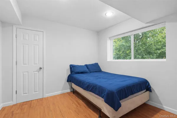 a bedroom with a bed and window