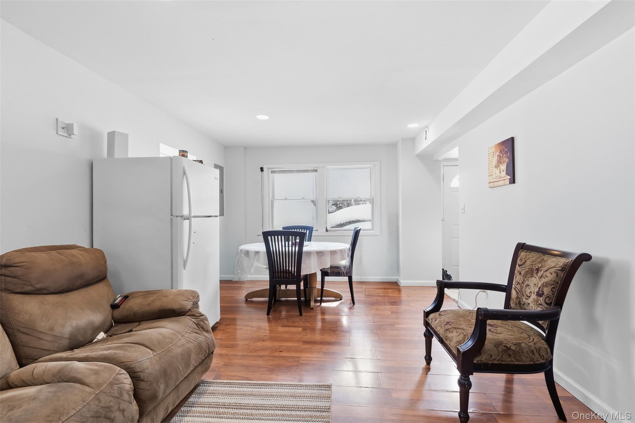 153 South Pascack Road Nanuet, NY 10954 - Photo 14 of 27 a living room with furniture a refrigerator and a dining table with wooden floor