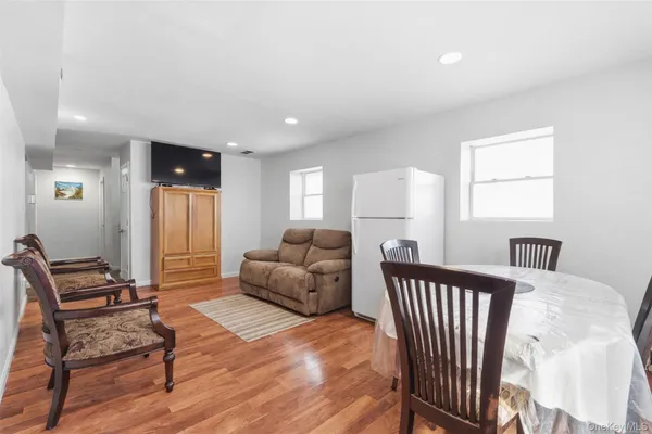 a bedroom with furniture and wooden floor