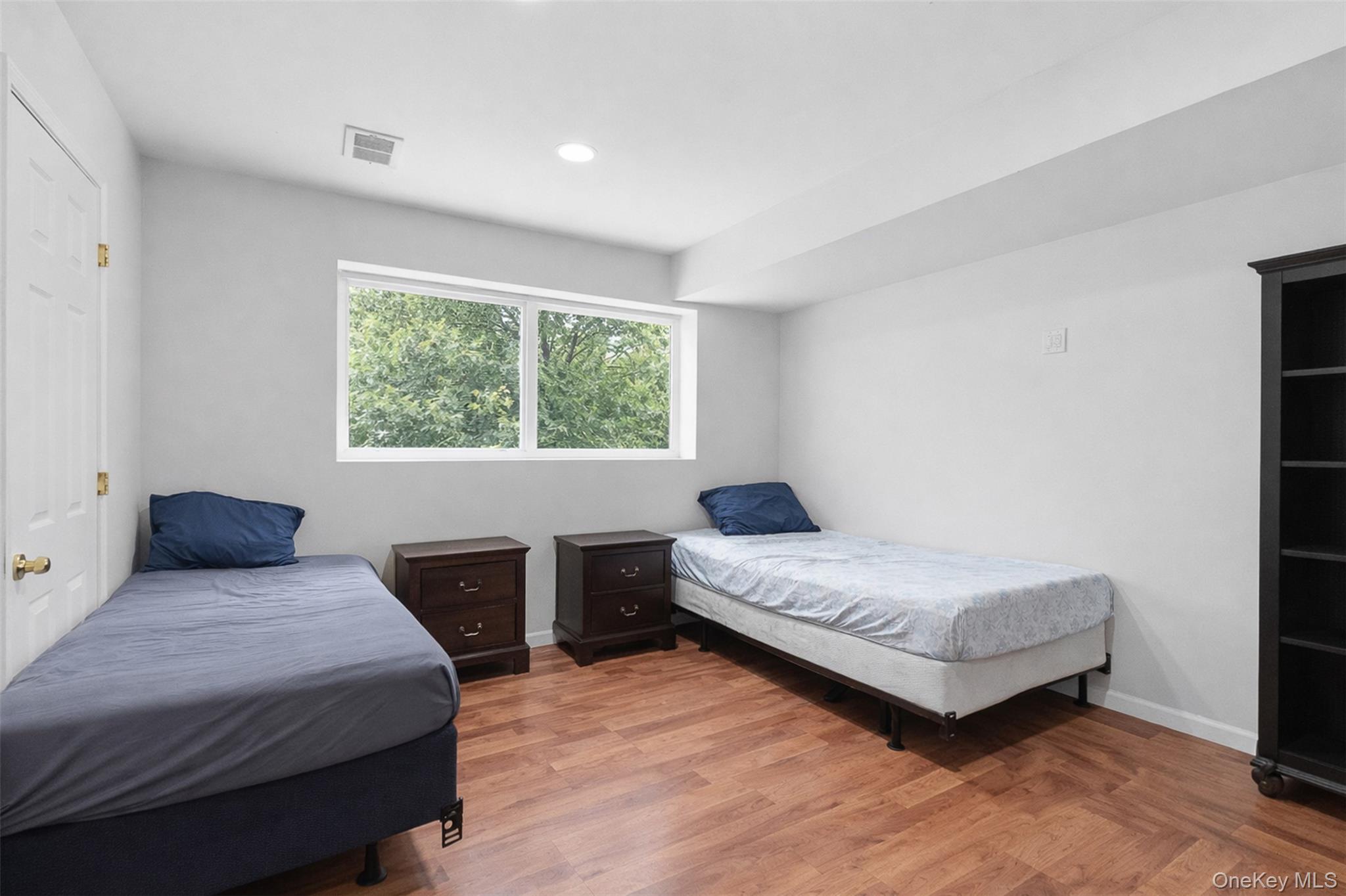 153 South Pascack Road Nanuet, NY 10954 - Photo 18 of 27 a bedroom with a bed and wooden floor