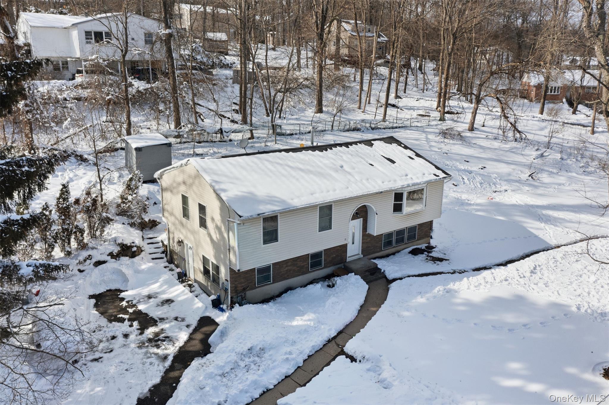 153 South Pascack Road Nanuet, NY 10954 - Photo 28 of 28 a view of a house with a yard covered with snow in the background