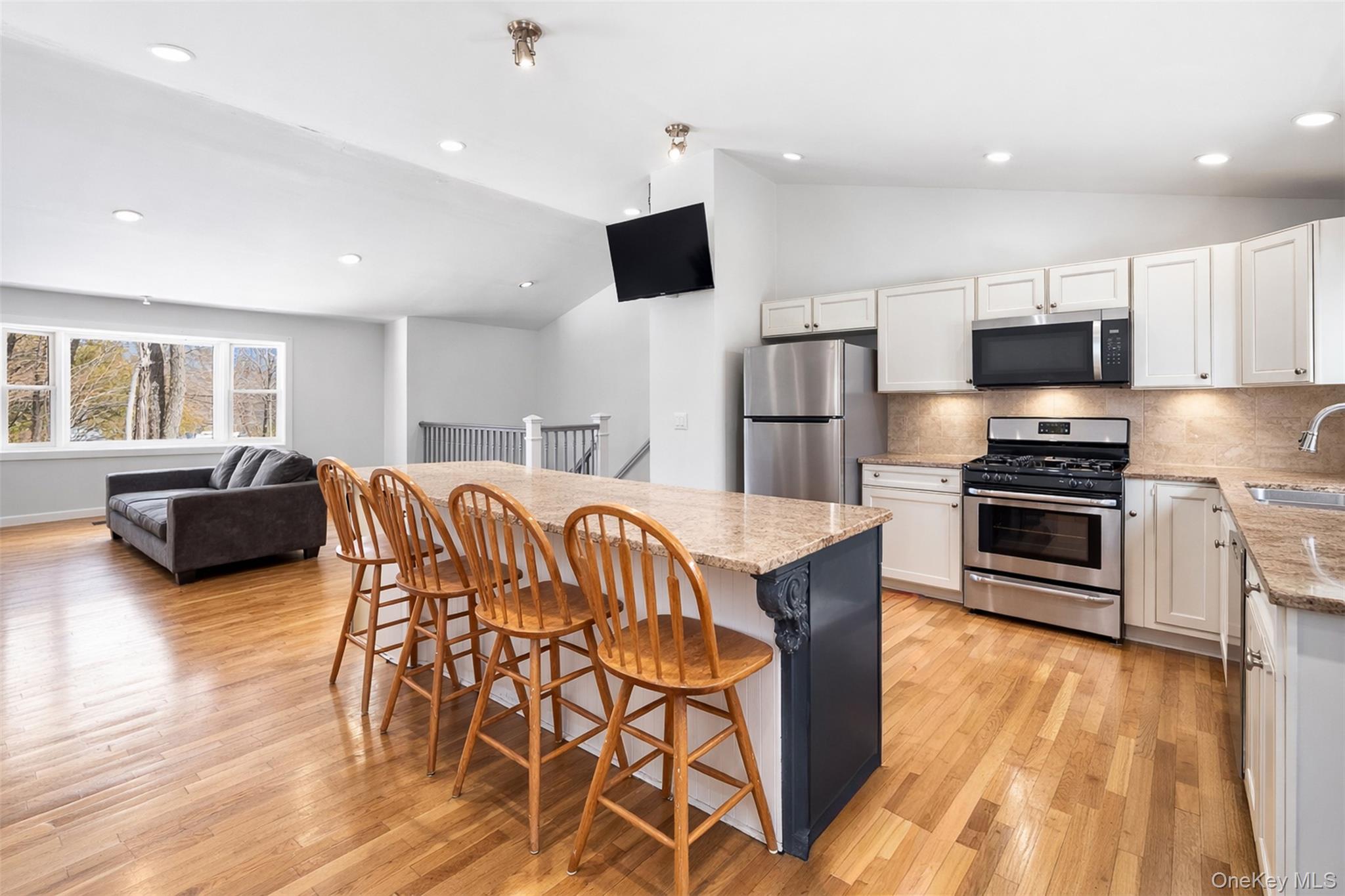 153 South Pascack Road Nanuet, NY 10954 - Photo 7 of 28 a kitchen with stainless steel appliances a stove a sink a microwave a refrigerator white cabinets and wooden floor