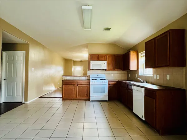a kitchen with stainless steel appliances granite countertop a sink and cabinets