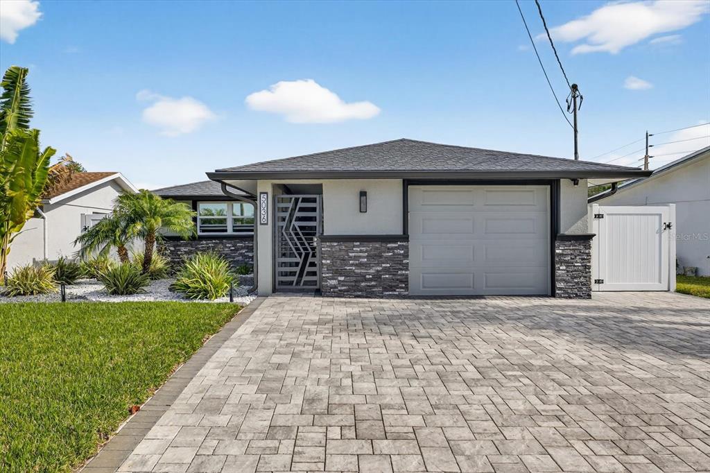 5036 Bonito Drive New Port Richey, FL 34652 - Photo 1 of 1 a front view of a house with a yard and garage