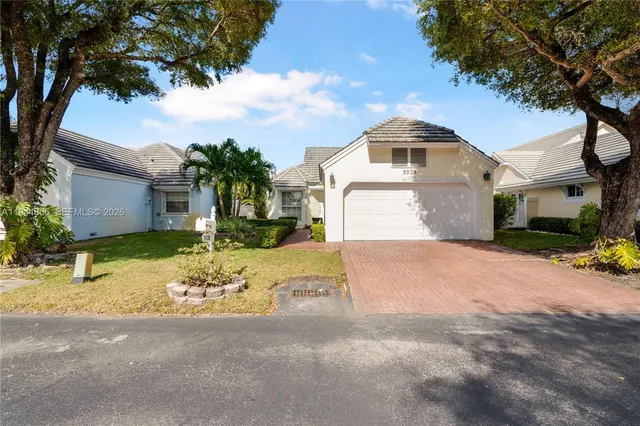 a front view of a house with a yard garage and outdoor seating
