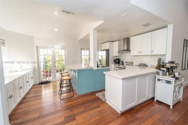 a kitchen with white cabinets and white appliances