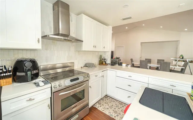 a kitchen with cabinets appliances and a window