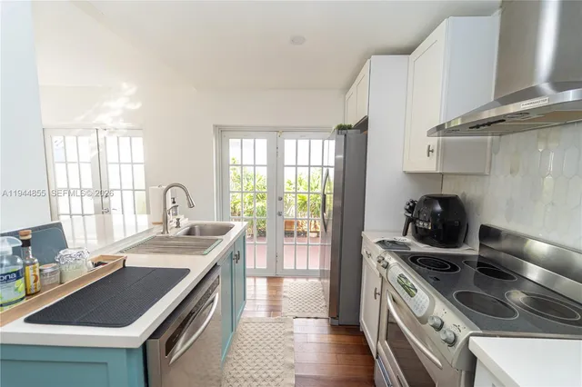 a kitchen with a sink a stove and a refrigerator