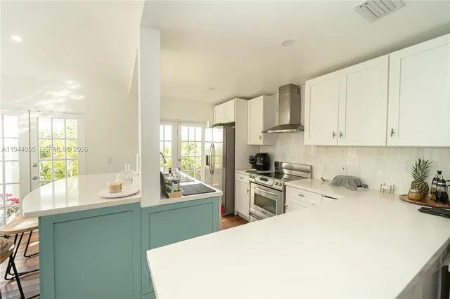 a kitchen with a sink stove and cabinets