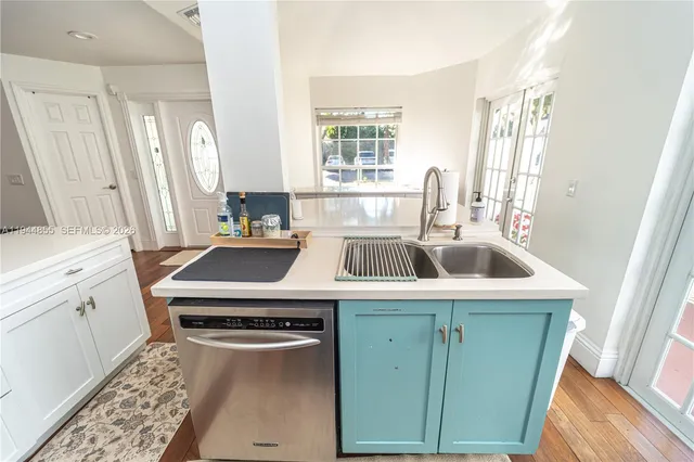 a view of a livingroom with wooden floor and furniture