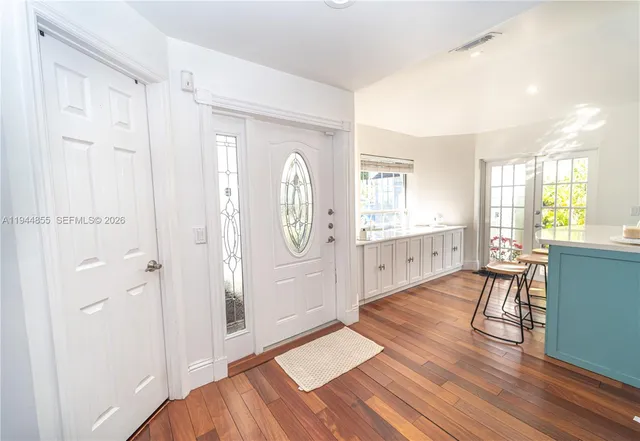 a bed room with a bed and a wooden floor