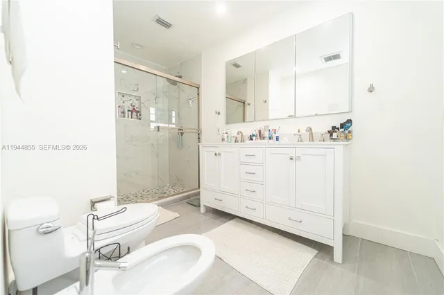 a bathroom with a toilet sink and a shower