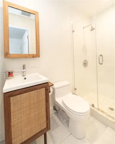 a large white bed in a white room