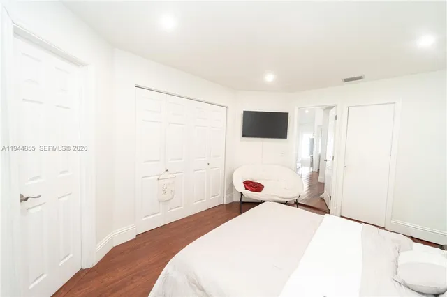 a view of a livingroom with furniture a ceiling fan and wooden floor