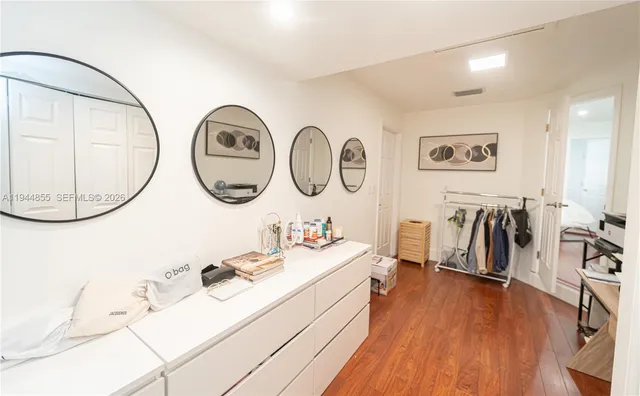 a front view of a house with a garden and yard