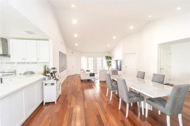 a large kitchen with a table and chairs