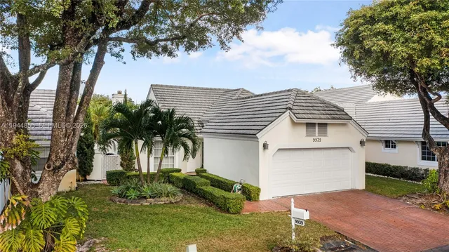 aerial view of a house with a yard and garden