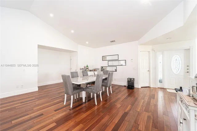 a dining room with furniture and wooden floor