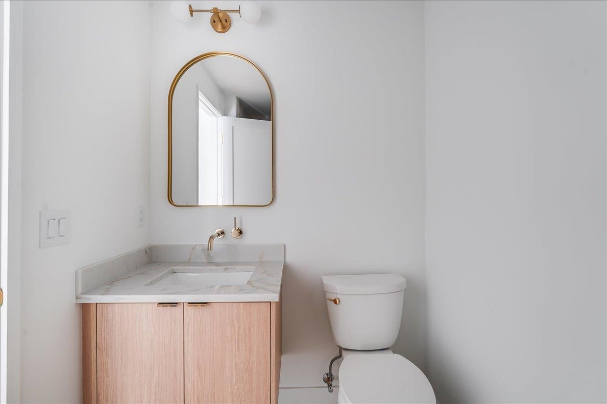 418 Monroe Street, Unit 201 Hoboken, NJ 07030 - Photo 20 of 29 a bathroom with a toilet sink and mirror