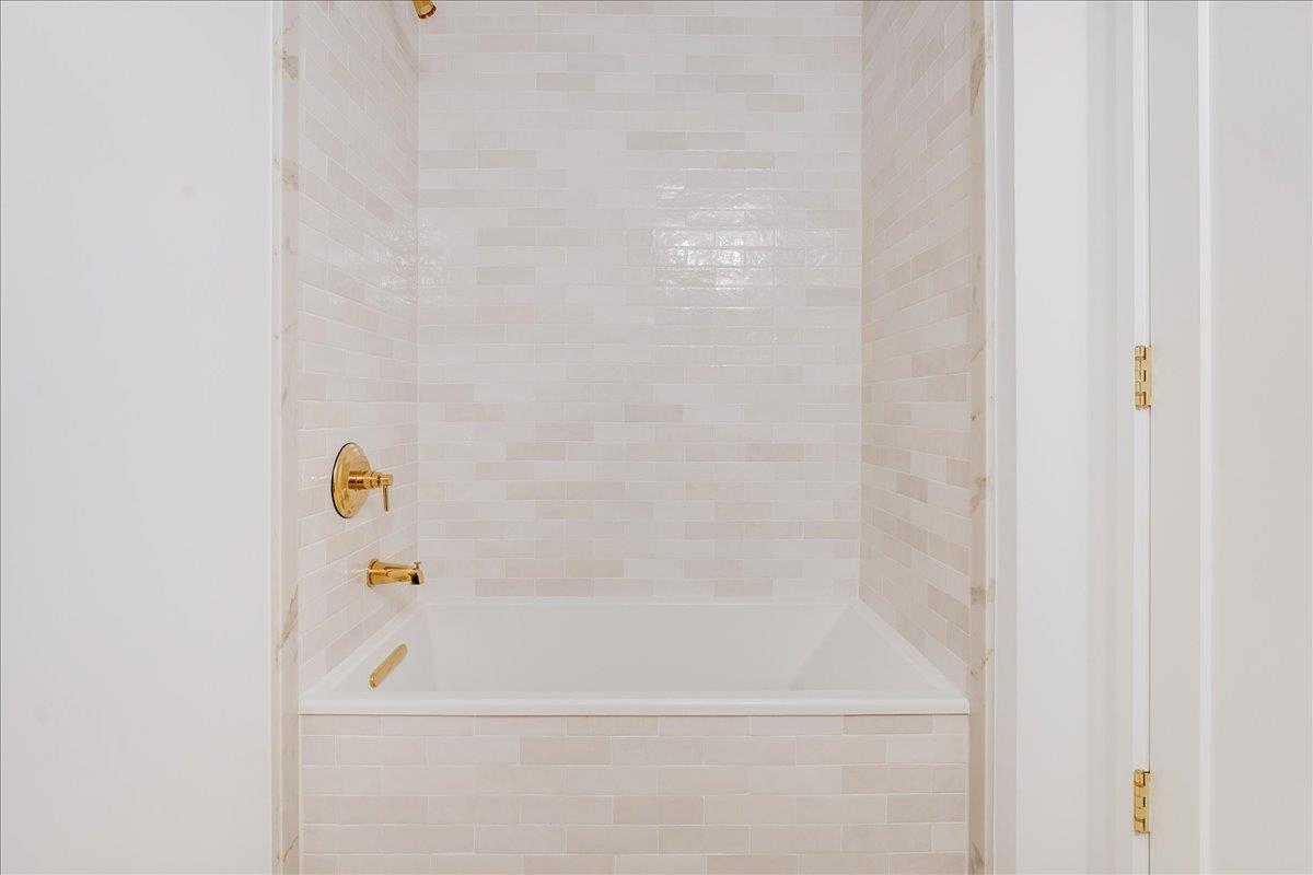 418 Monroe Street, Unit 201 Hoboken, NJ 07030 - Photo 24 of 29 a bathroom with a bathtub