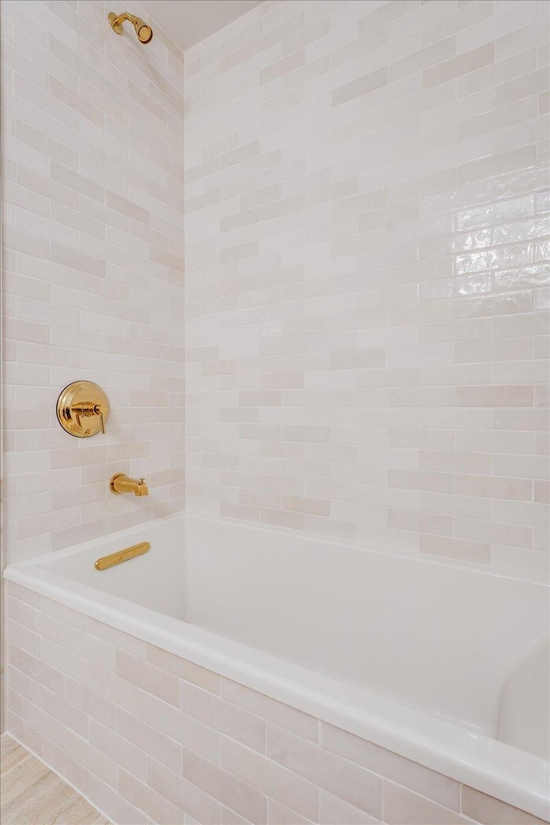418 Monroe Street, Unit 201 Hoboken, NJ 07030 - Photo 25 of 29 a bathroom with a bathtub