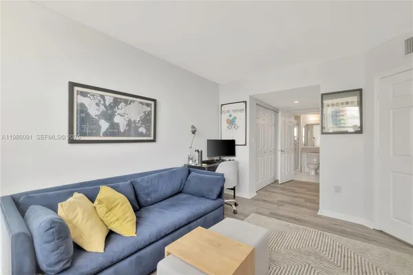 a living room with furniture and a rug