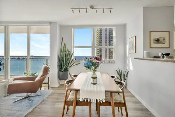 a view of a dining room with furniture window and wooden floor