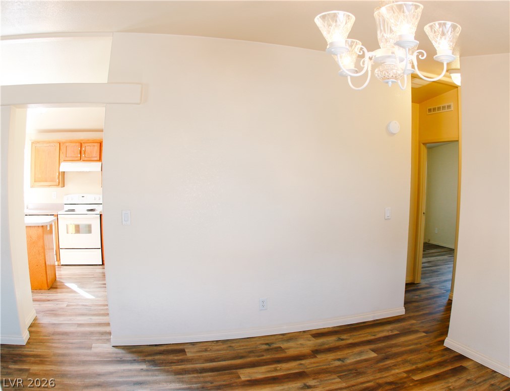 5231 Ruby Way Caliente, NV 89008 - Photo 15 of 35 Durable plank flooring extends throughout this adaptable room, illuminated by a decorative chandelier.