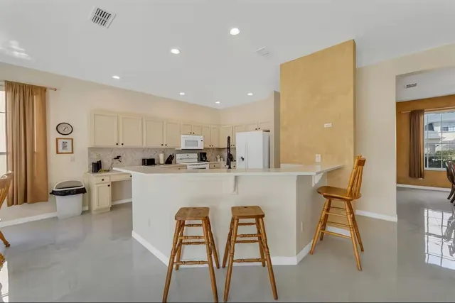 a large kitchen with a large window and counter space