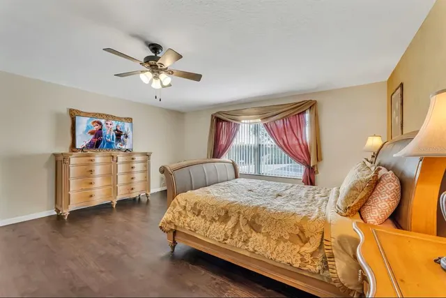 a bed sitting in a bedroom next to a window