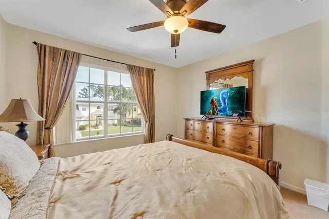 a view of a hallway with furniture and floor to ceiling window