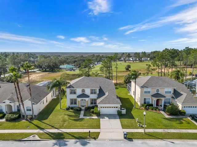 a kitchen with white cabinets appliances and a sink