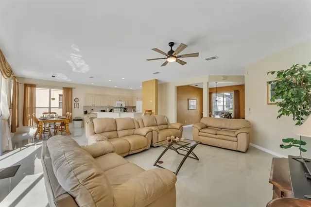a open kitchen with a sink dining table and chairs