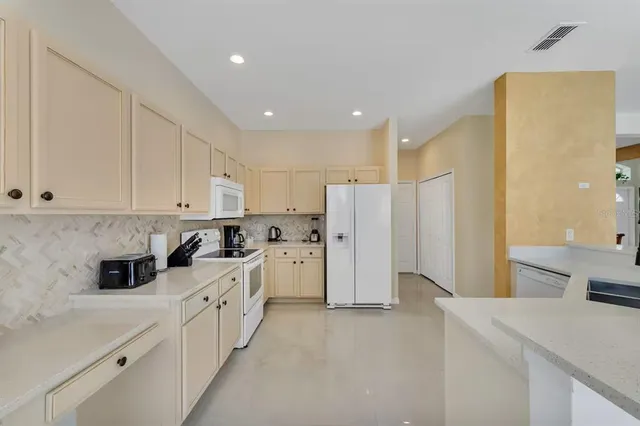 a view of a dining room with furniture and a chandelier