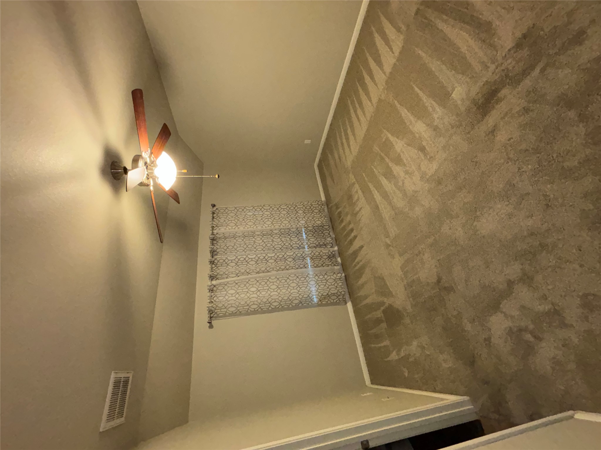 634 River Bluff Circle Georgetown, TX 78626 - Photo 22 of 37 Empty room featuring dark colored carpet, ceiling fan, and lofted ceiling